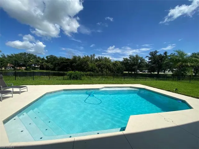 View of pool with a yard
