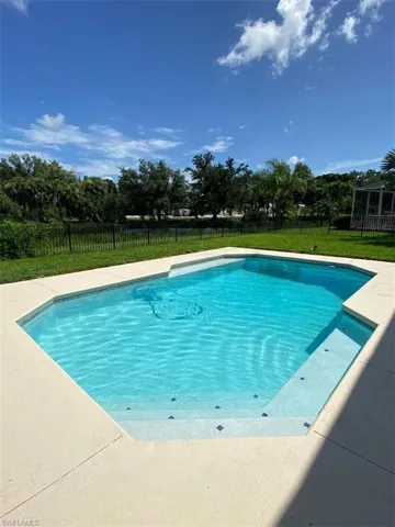 View of swimming pool with a yard