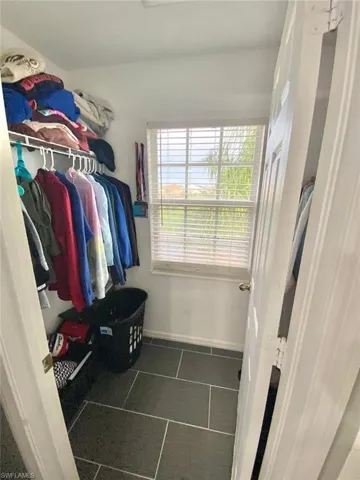 Spacious closet with dark tile patterned flooring