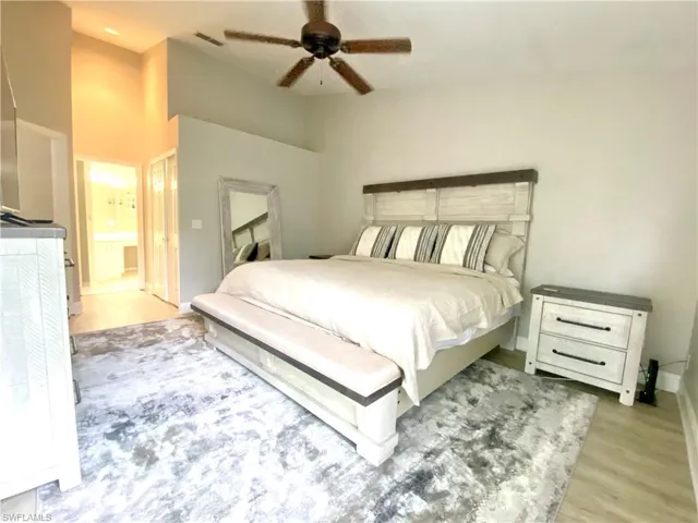 Main Bedroom with ceiling fan, ensuite bathroom, and light hardwood / wood-style flooring and king size bed