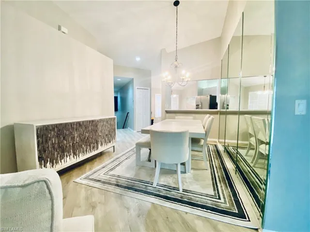 Dining space featuring a notable chandelier and hardwood / wood-style floors