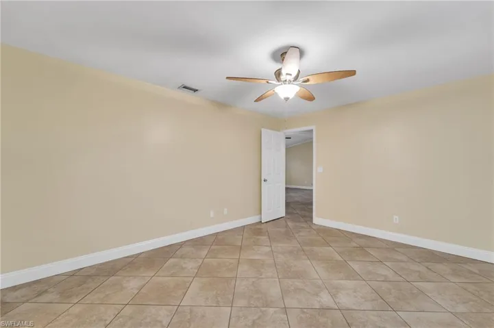 Spare room featuring baseboards and ceiling fan