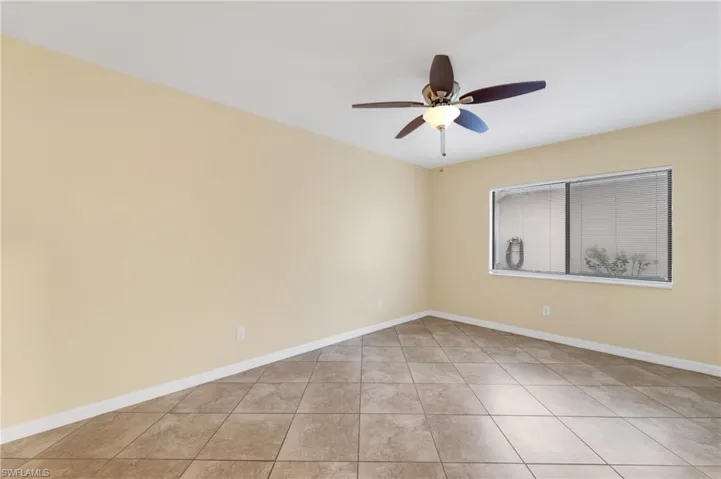 Spare room featuring light tile patterned floors and a ceiling fan