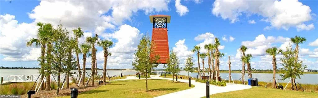 Surrounding community featuring a water view and a lawn