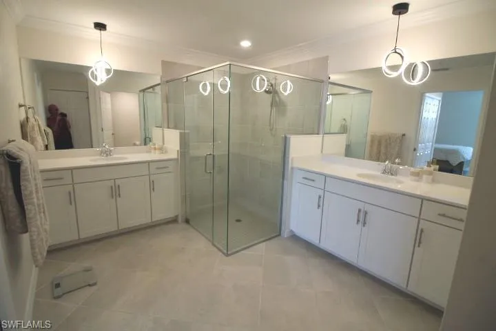 Bathroom with w/dual vanities, water closet, designer lighting and tiled flooring