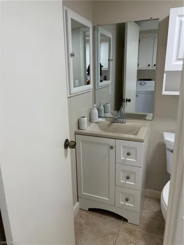 Updated Bathroom with tile patterned flooring  and vanity