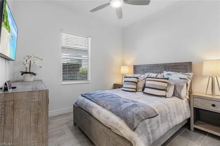 Bedroom featuring wood-type flooring and ceiling fan