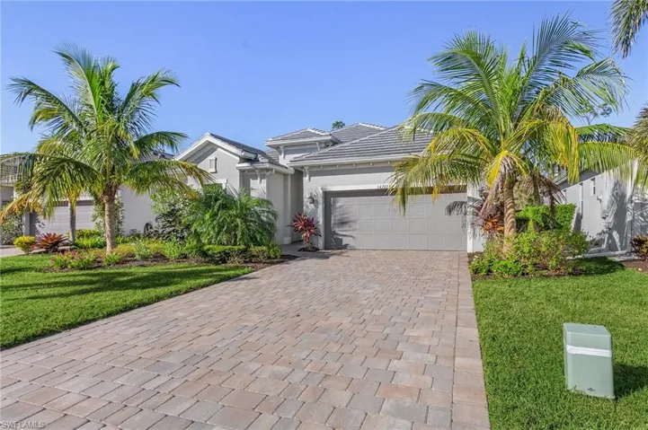 View of front of house featuring a front lawn and a garage