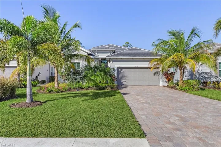 View of front of home featuring a front lawn and a garage