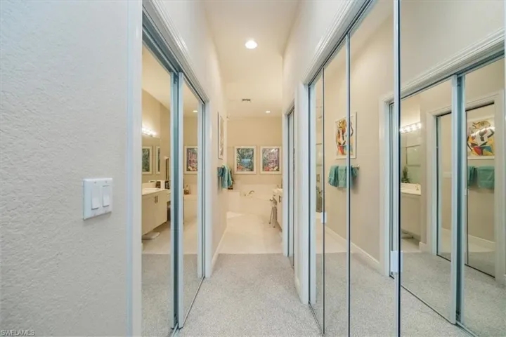 Hall featuring light carpet and recessed lighting