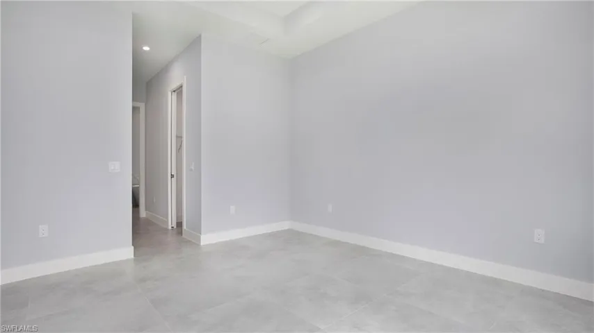 Empty room with concrete floors and recessed lighting