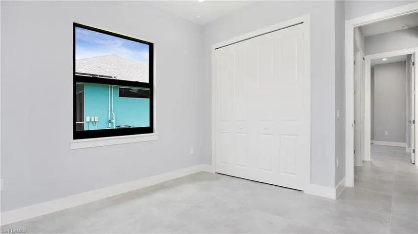 Unfurnished bedroom featuring a closet and concrete floors