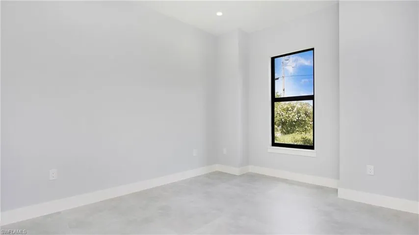 Spare room with concrete floors and baseboards