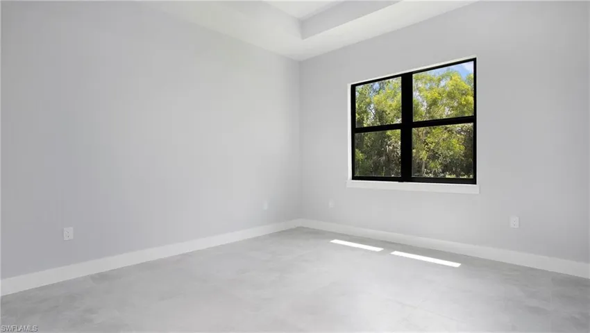 Empty room featuring baseboards