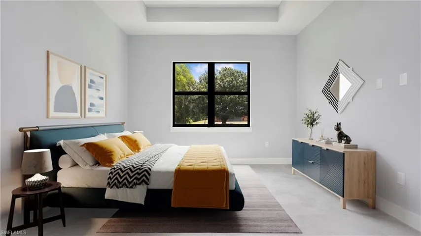 Carpeted bedroom featuring baseboards and a raised ceiling