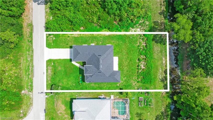 Aerial view of property and surrounding area with property boundaries highlighted