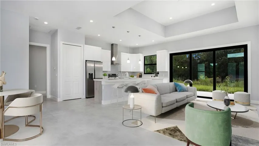Living room with recessed lighting and concrete floors