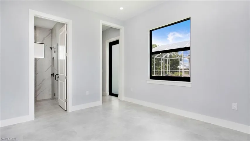Unfurnished bedroom featuring baseboards and finished concrete floors