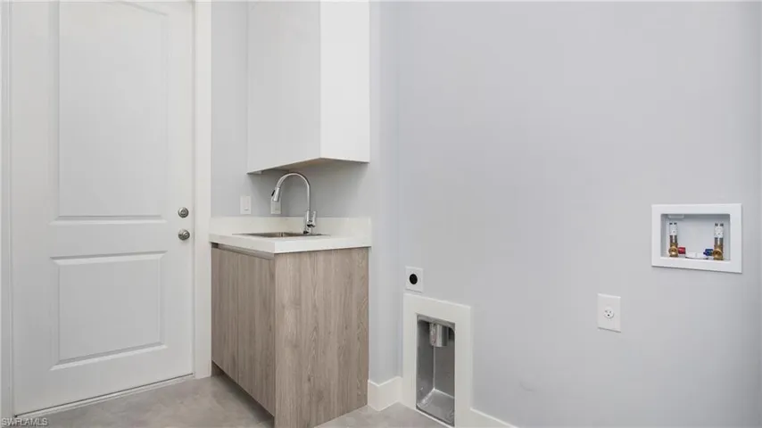Washroom featuring hookup for an electric dryer and hookup for a washing machine