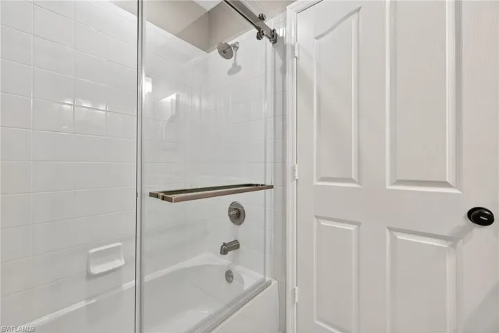 Full bath with shower / bath combination with glass door