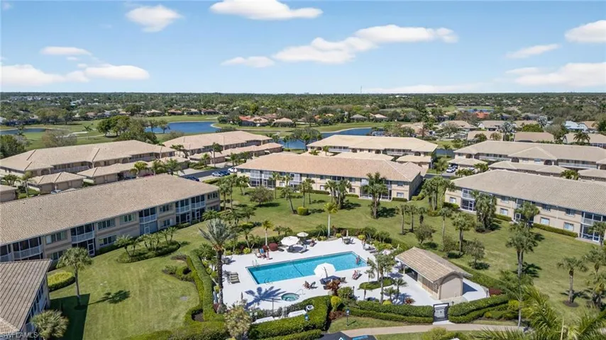 Aerial view of a pool area and a nearby body of water