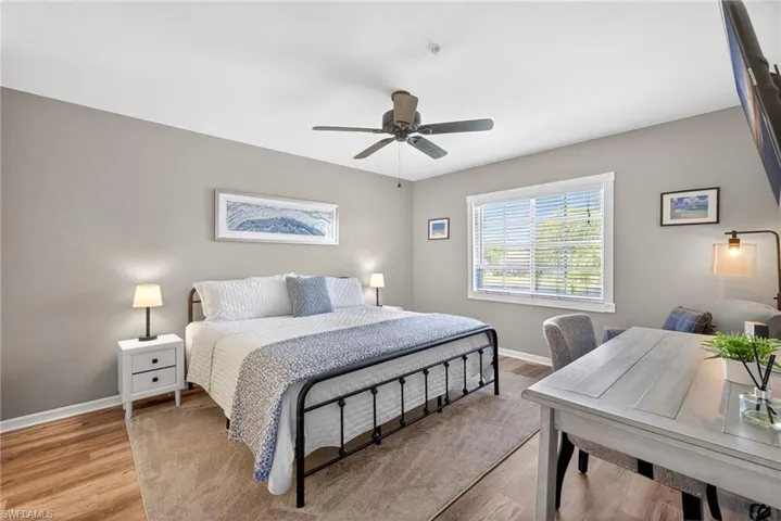 Bedroom with wood finished floors and a ceiling fan