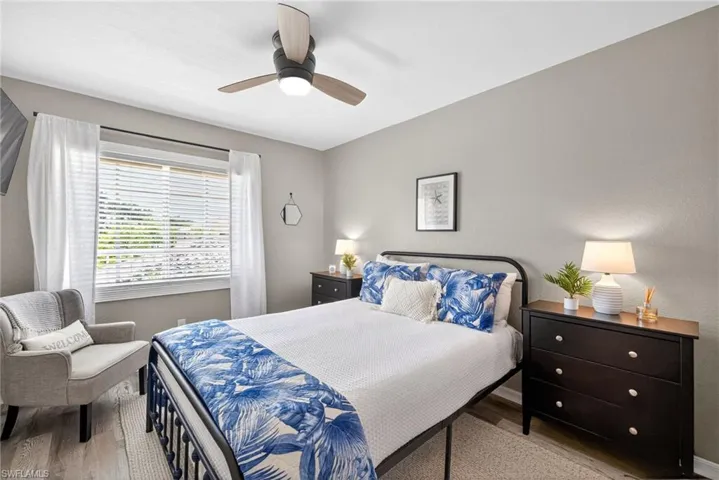 Bedroom with light wood-style floors and a ceiling fan