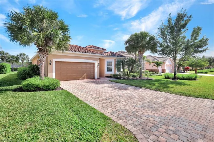 Front view of the home with pavered driveway.