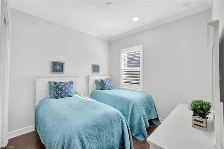 Bedroom #2 with hardwood floor and plantation shutters and closet (not shown).