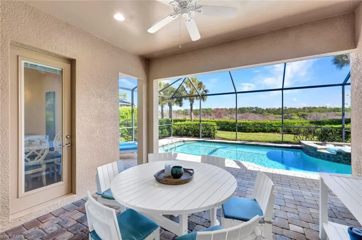 Covered outdoor area on the lanai with views of the pool, spa and the preserve.