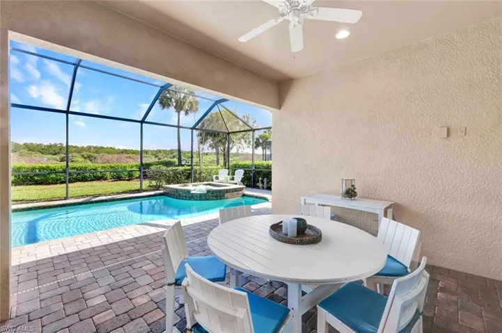 Covered outdoor area on the lanai with views of the pool, spa and the preserve.