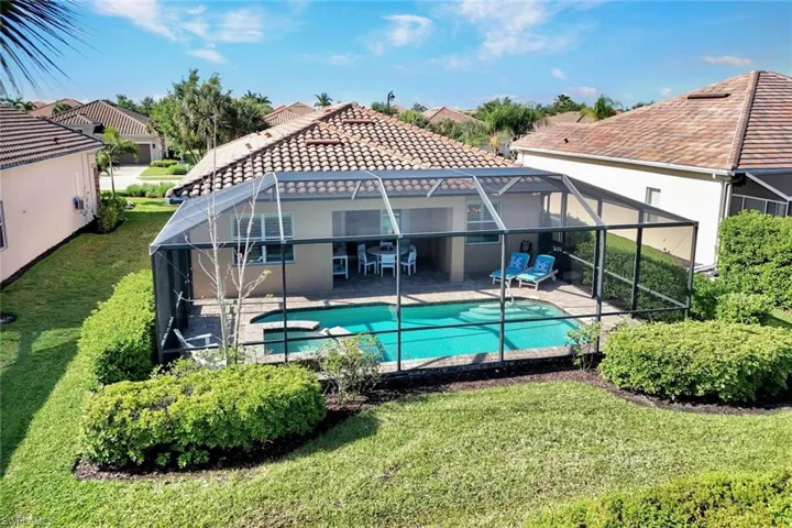 Aerial view of the home with enclosed pavered lanai, pool, spa and covered outdoor area.