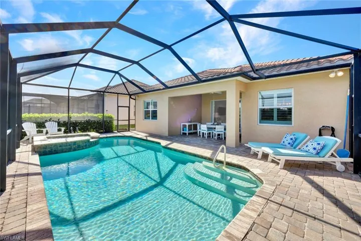 Pavered lanai with views of the pool, spa and the covered outdoor area.