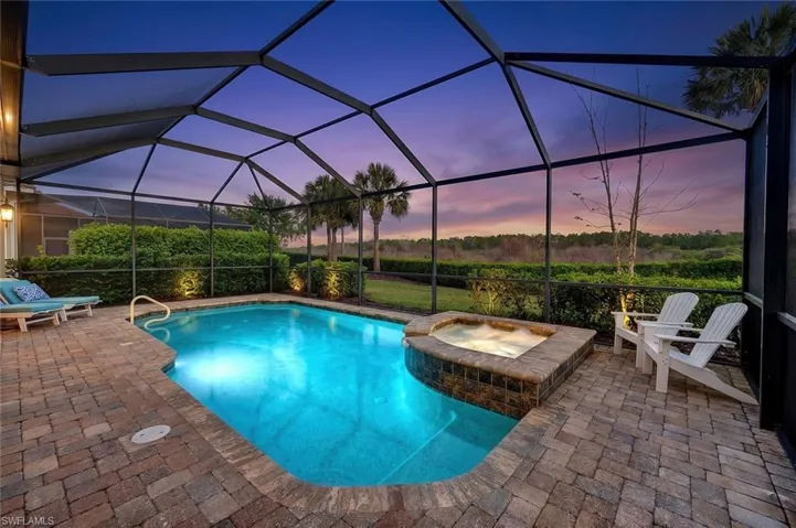 Lanai with pavers, pool and spa at sunrise