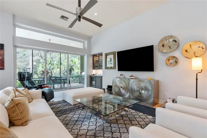 Living room featuring a ceiling fan, wood finished floors, and recessed lighting