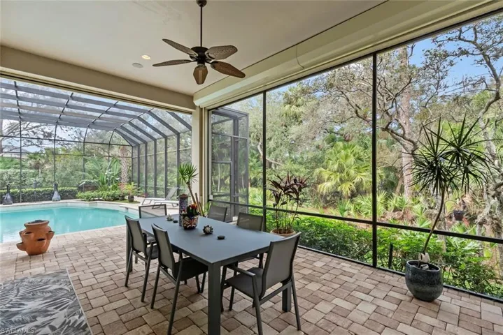 Sunroom with a ceiling fan and outdoor dining space