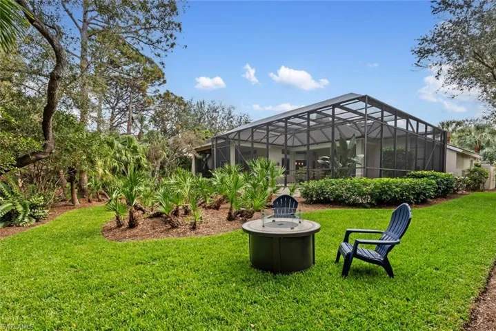 View of grassy yard featuring a lanai