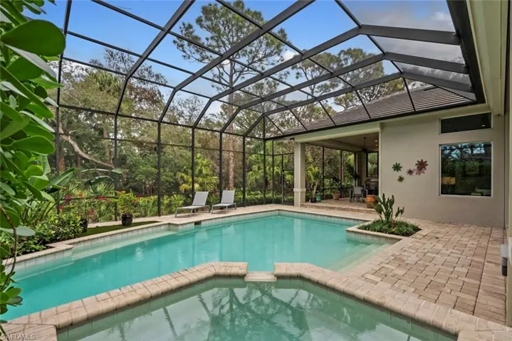 View of swimming pool with a patio, a pool with connected hot tub, a ceiling fan, and a lanai
