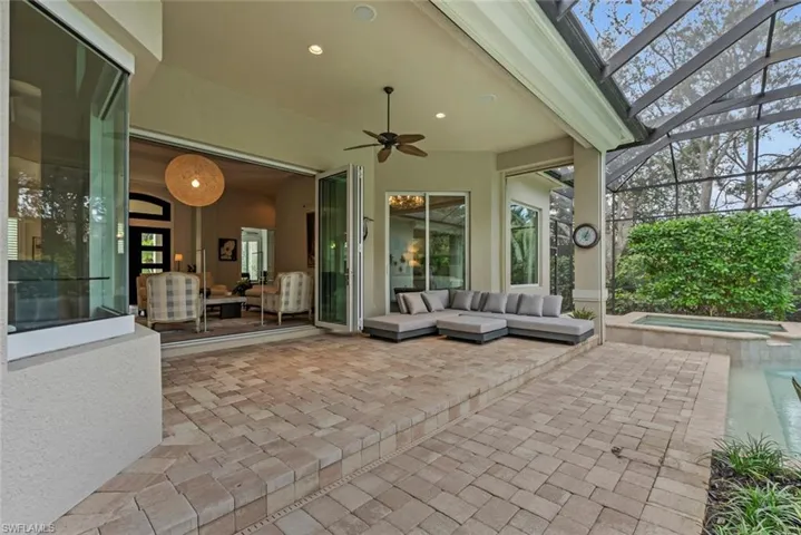 View of patio / terrace with a ceiling fan, an outdoor hangout area, a lanai, and a pool with connected hot tub