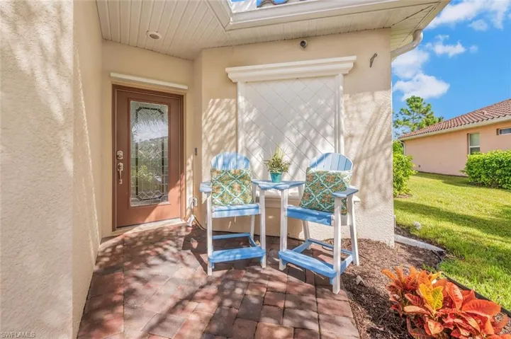 Doorway to property featuring a lawn