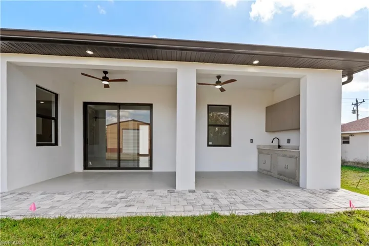 View of patio / terrace featuring a ceiling fan and an outdoor kitchen