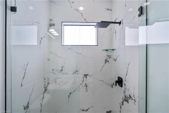 Bathroom featuring a marble finish shower