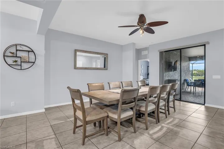 Tiled dining space featuring ceiling fan