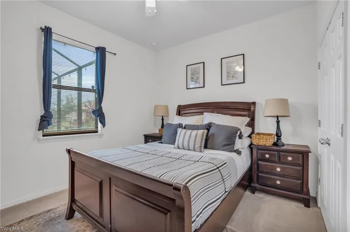 Carpeted bedroom with ceiling fan