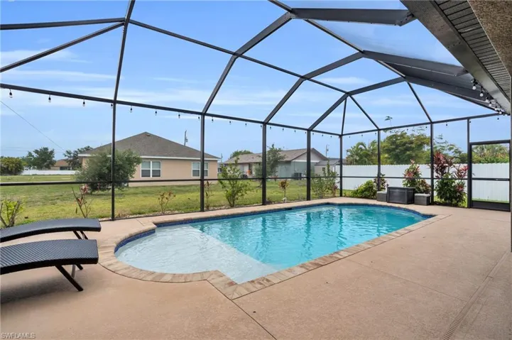 View of swimming pool with a patio area, a lanai, and a yard