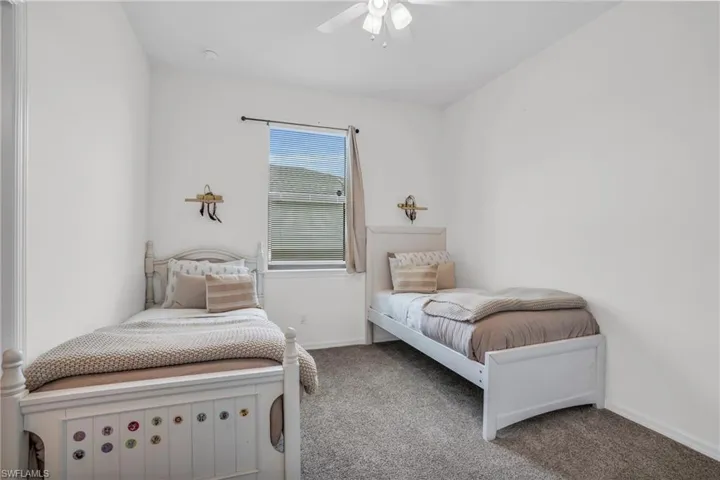 Carpeted bedroom with ceiling fan