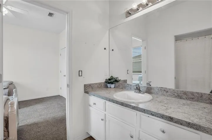 Bathroom with oversized vanity and ceiling fan