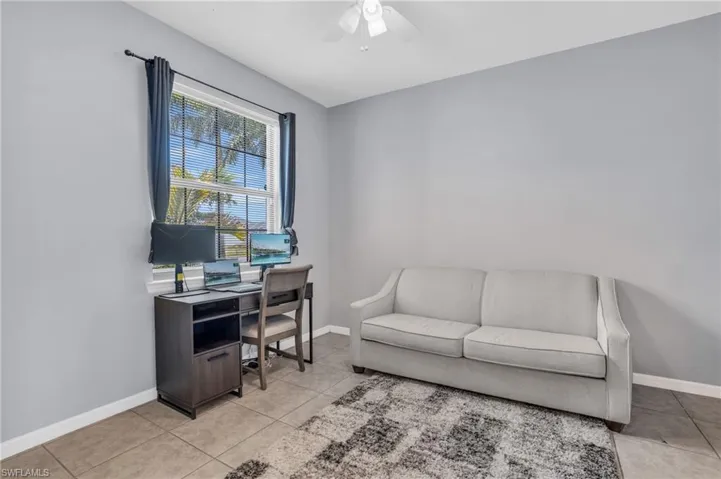 Tiled office featuring ceiling fan