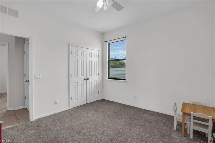 Bedroom featuring carpet, a closet, and ceiling fan