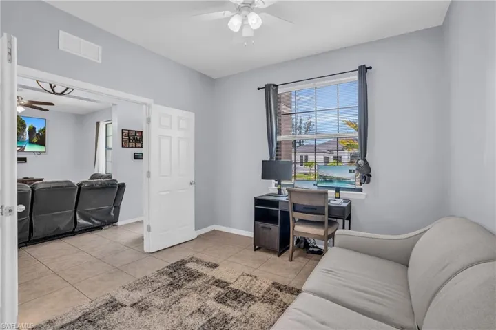 Office area featuring light tile flooring and ceiling fan